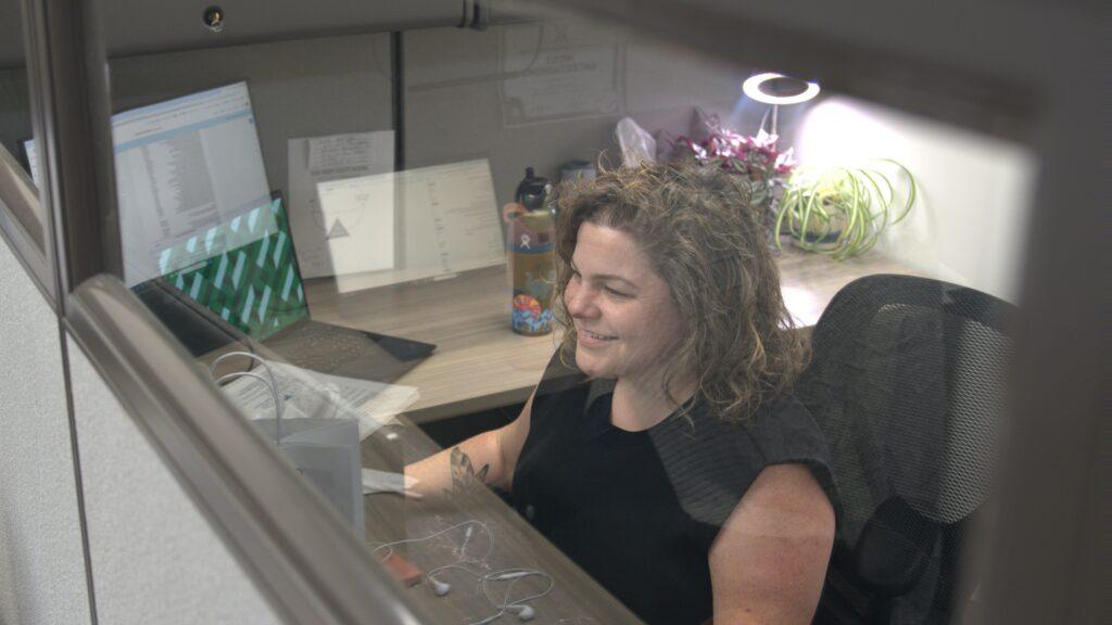 Kelly Richards working at a desk at the VHI headquarters